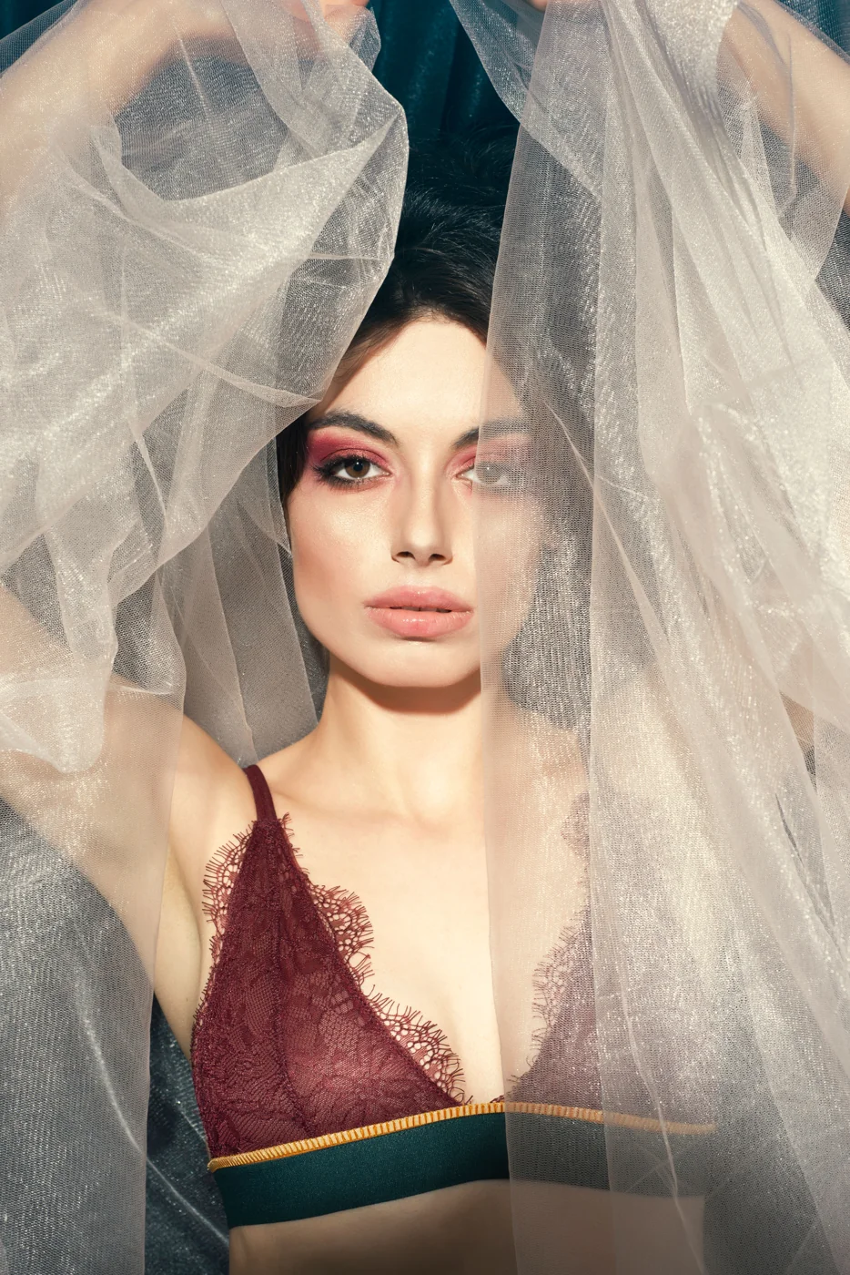 Portrait framed by sheer fabric