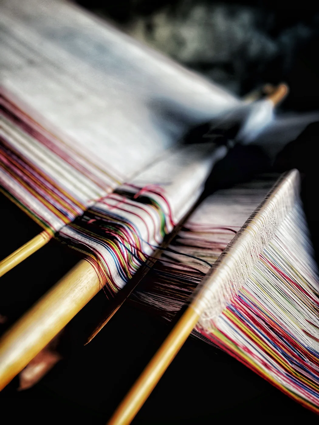 Detail of coloured threads on a loom